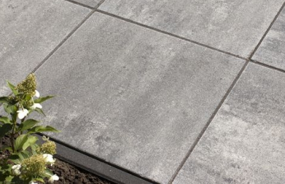 Gele trilplaat en grijze terrastegels